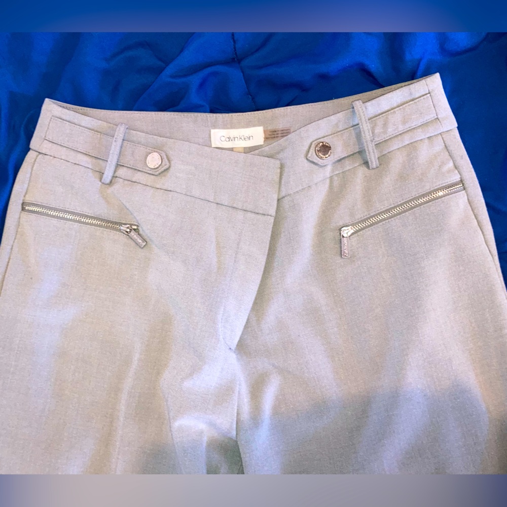 CK dress pants, gray with pleat, hook and zipper. Front pockets with zipper